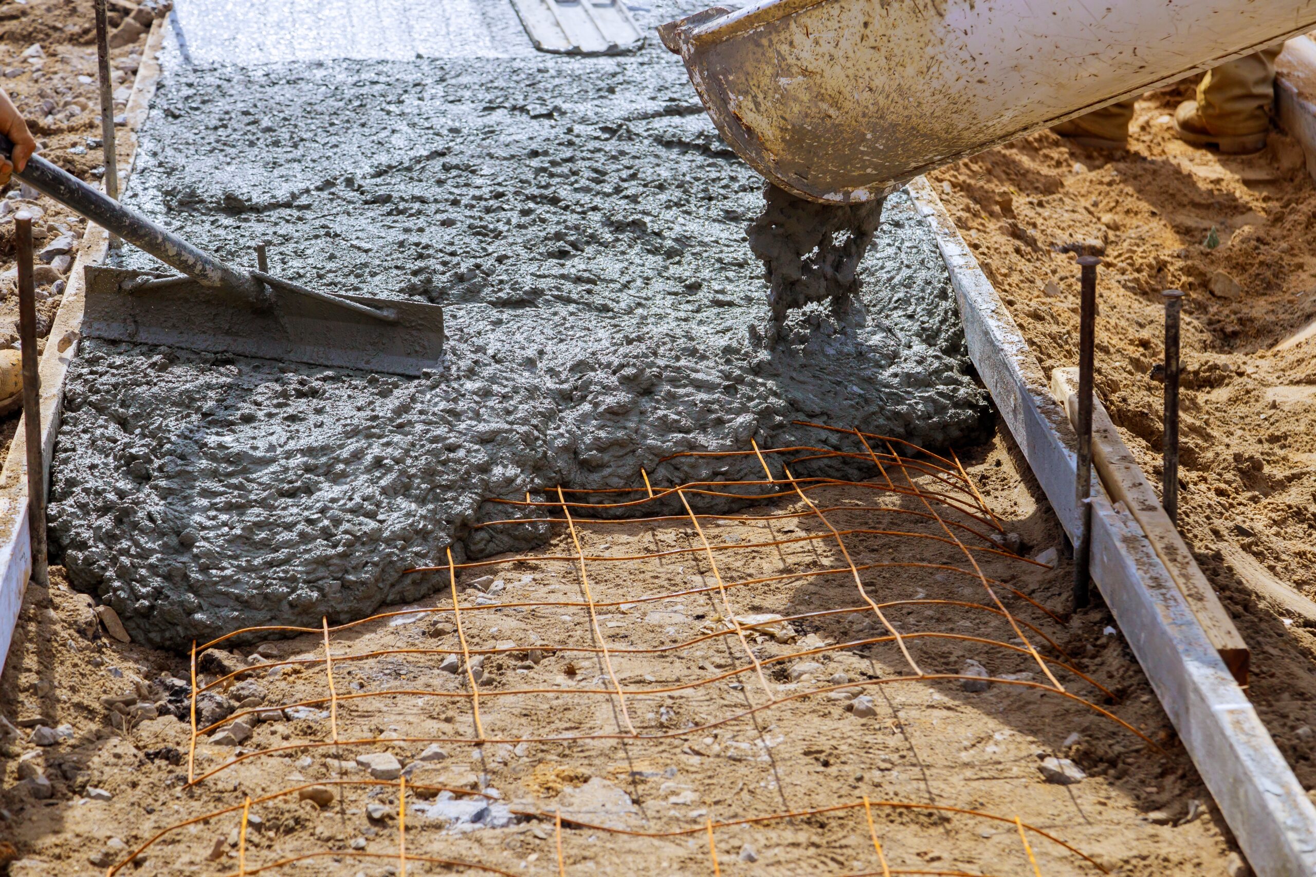Worker working for concrete pavement for ground at construction